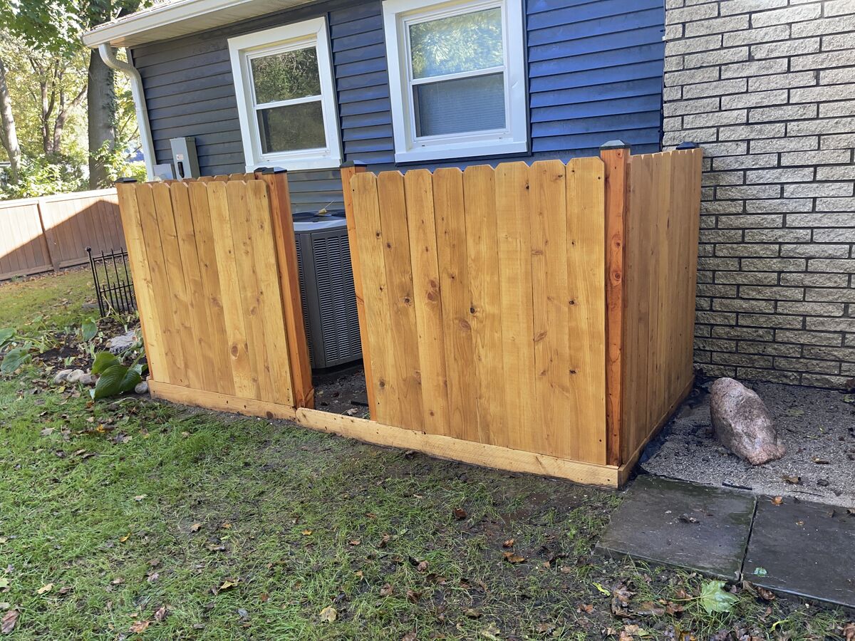 Freshly stained cedar privacy fence screening an outdoor AC unit, Novi MI