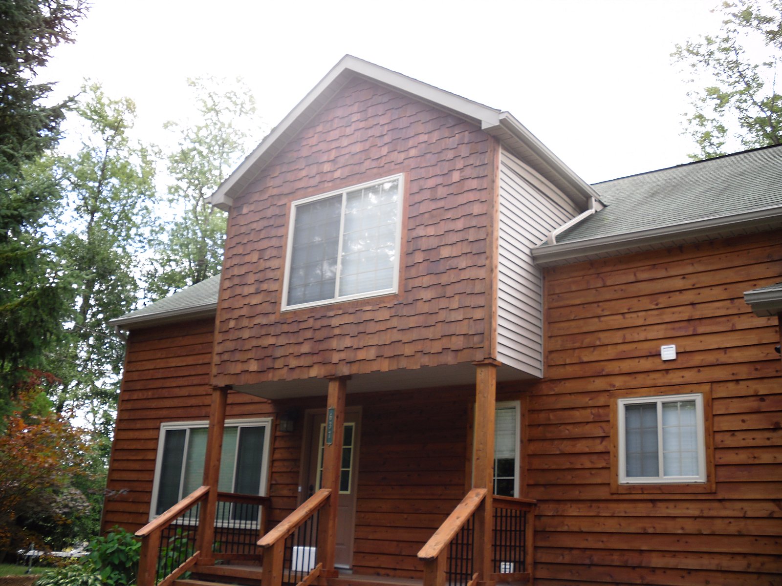 Freshly stained cedar-toned home exterior in Clarkston, MI